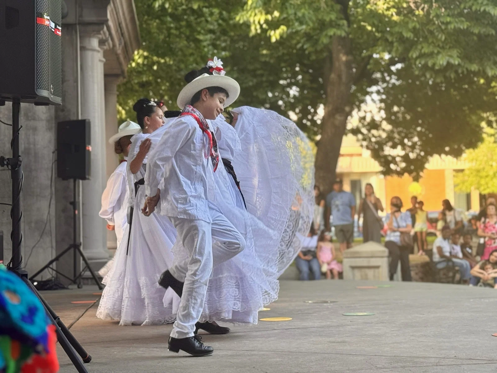 Ballet Folklórico dancers performing on stage before an audience
