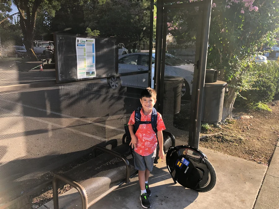 Rhys Stone at a B-Line stop near his daycare and Bidwell Park’s Chico Creek Nature Center, beside the family electric unicycle