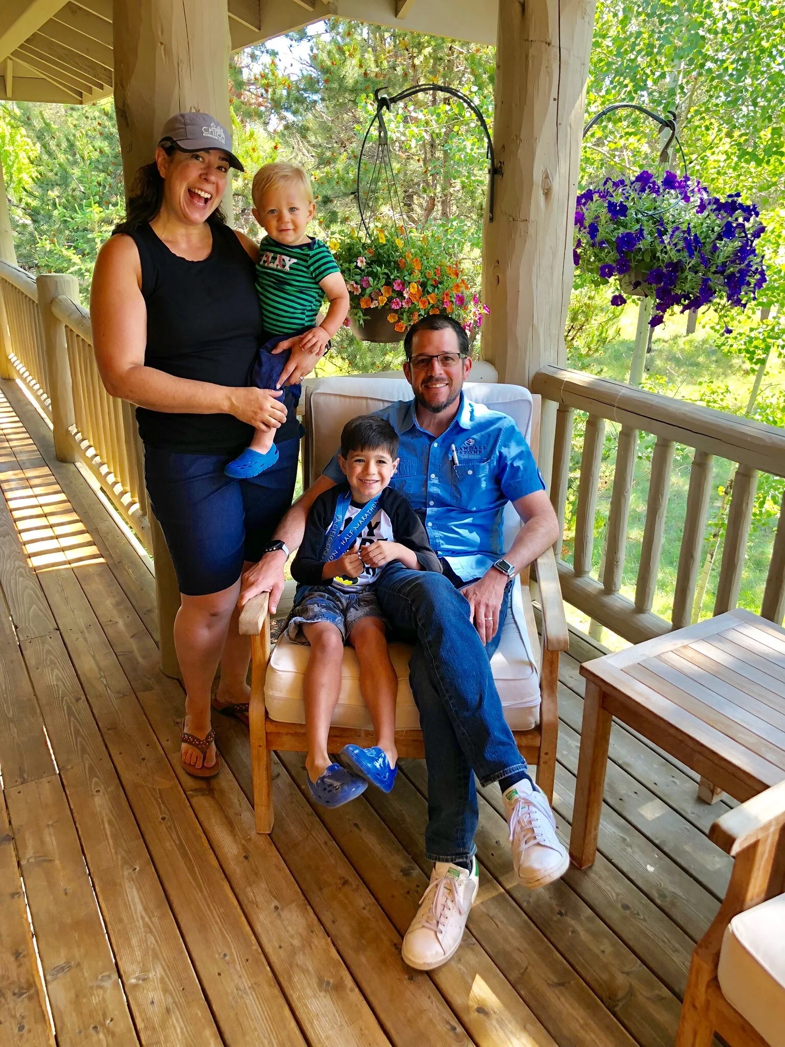 Krista and Randall Stone with Rhys and Karden on a porch