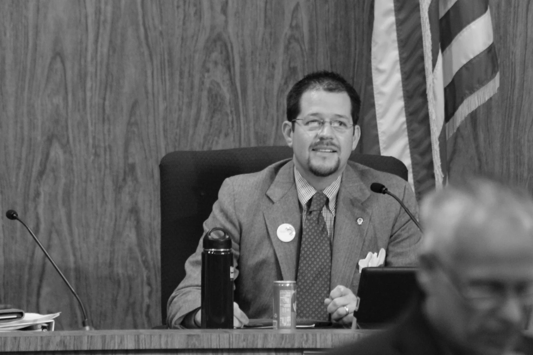 Black-and-white photograph of Randall Stone at the Chico City Council dais
