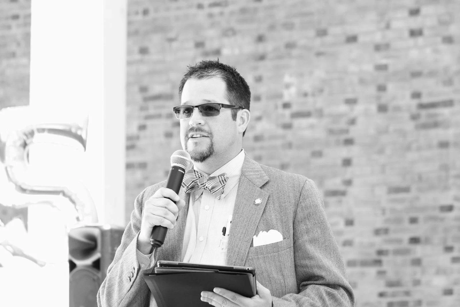 Randall Stone speaking into a microphone at a public event
