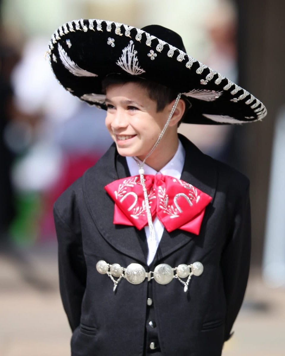 Rhys Stone smiling in black charro attire and sombrero